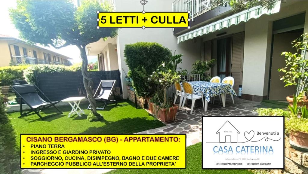 a house with a table and chairs in a yard at Casa Caterina in Cisano Bergamasco