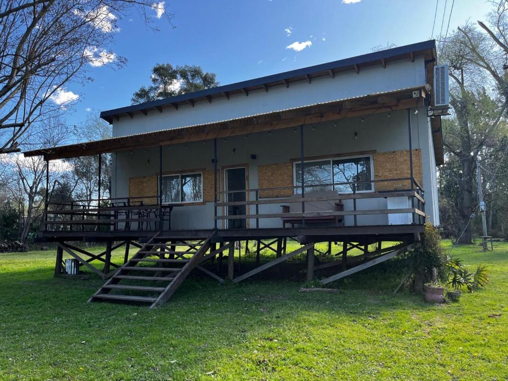 a house with a large deck on the grass at Isla La Scaloneta in Estación Delta