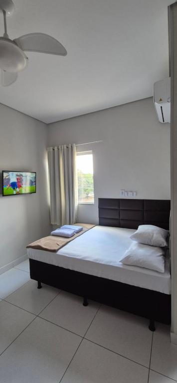 a large bed in a room with a window at AP Novo, Bem Localizado, Ar-Condicionado in Montes Claros
