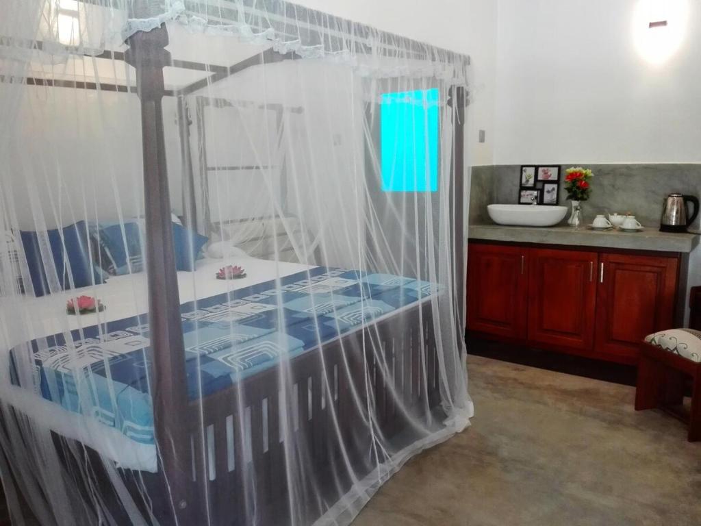 a bedroom with a bed with a shower curtain at Room No2 in Galle