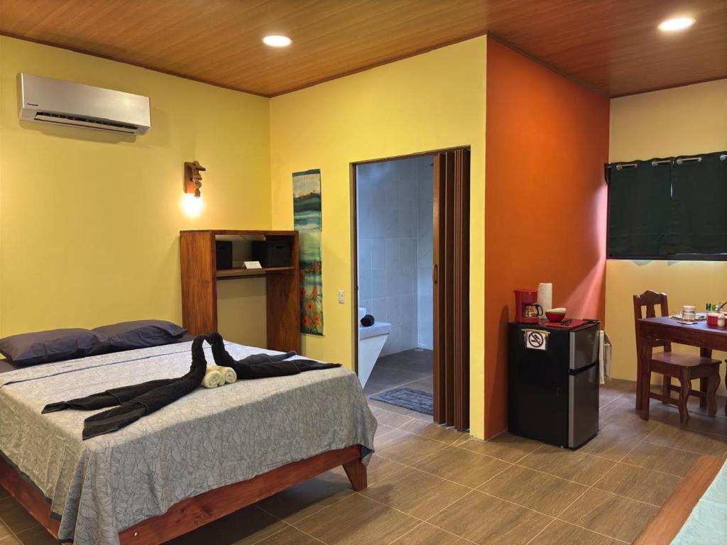 a bedroom with a bed and a dining room at Willy's Fish Camp Private Cabin, Drake Bay, Costa Rica in Drake
