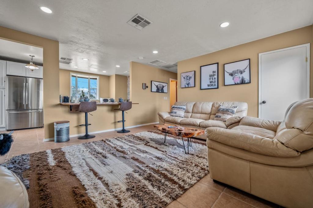 a living room with two couches and a rug at Jt Desert Dwelling in Twentynine Palms