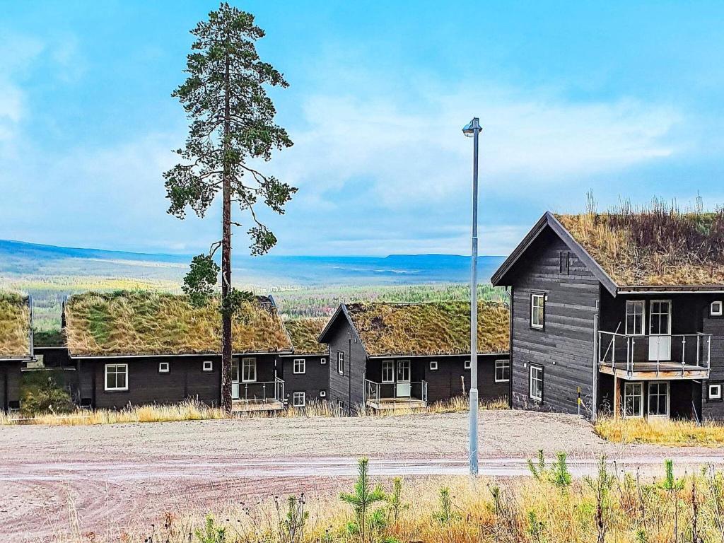 a row of black buildings with grass on their roofs at 8 person holiday home in SÄLEN-By Traum in Sälen