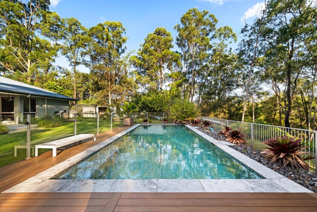 a swimming pool in the backyard of a house at Hinterland Retreat 5 bedrooms, pool & hot tub in Gold Coast