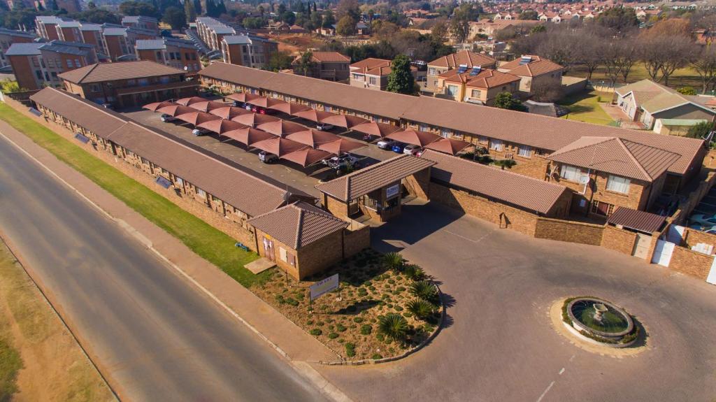 an overhead view of a building with a road at Rudman Townhouses - OR Tambo Airport in Boksburg