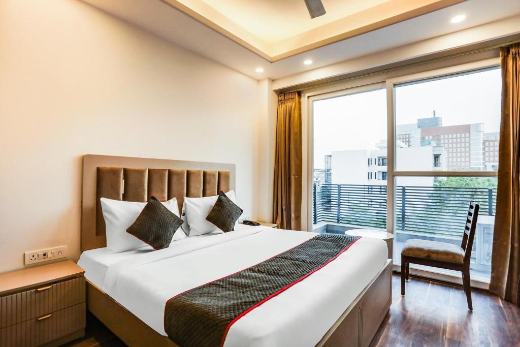 a bedroom with a large bed and a large window at Super Townhouse MA-32 in Gurgaon