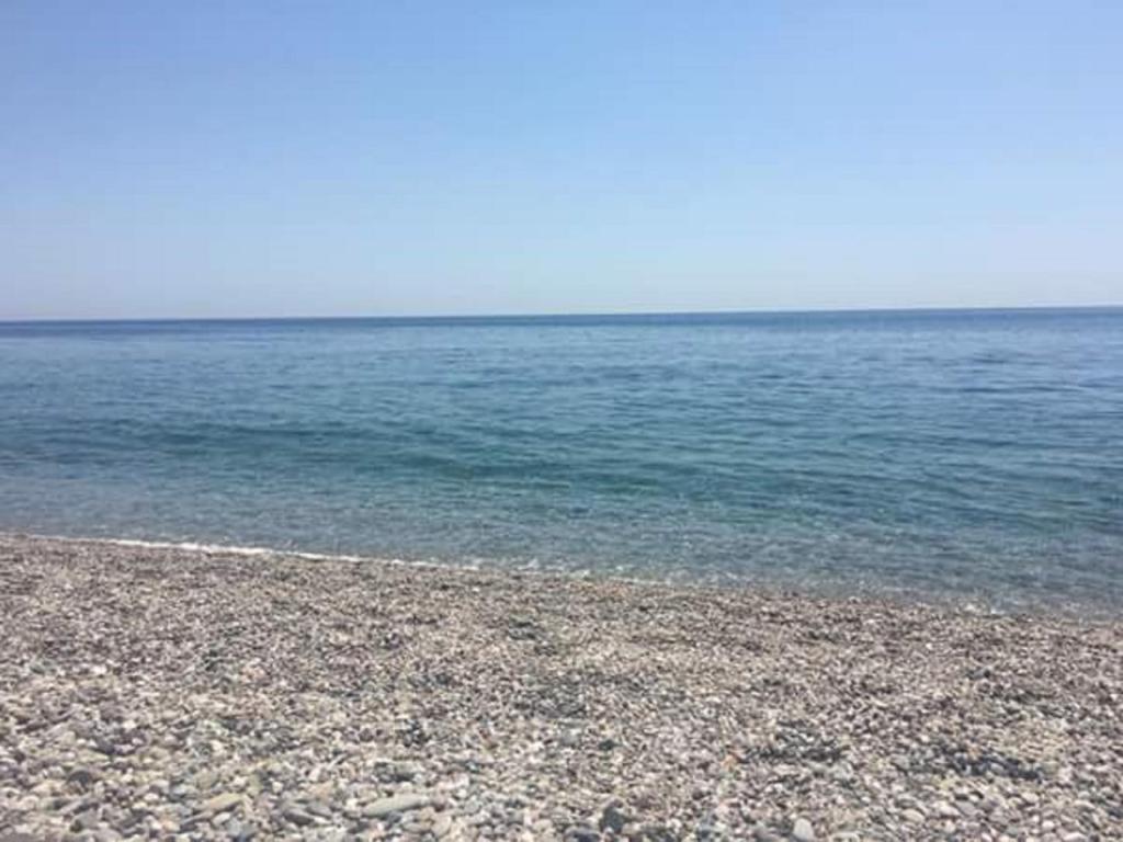 a rocky beach with the ocean in the background at Casa Holiday Sea Etna Di Enza in Linguaglossa