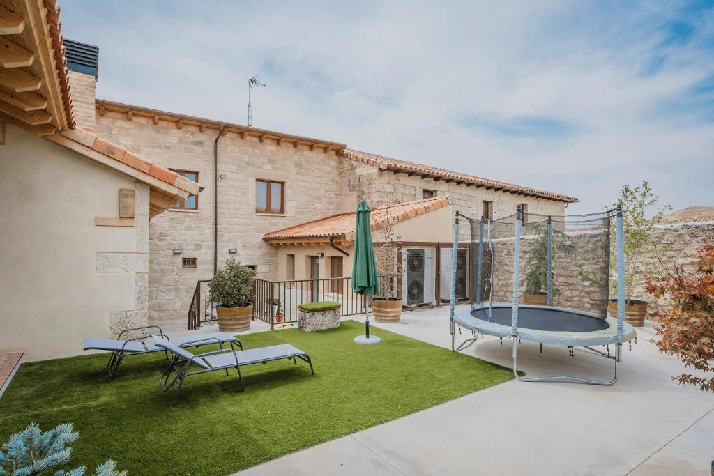 a patio with a trampoline in a yard at Casa Rural Vallehermoso 