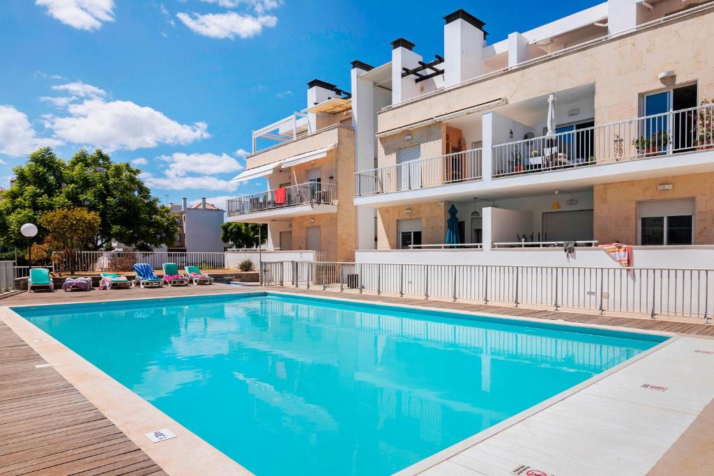 a swimming pool in front of a building at Clos des Lyces in Santa Luzia