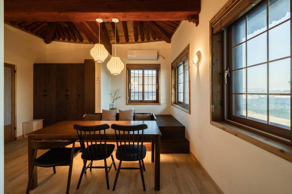 a dining room with a wooden table and chairs at Luxury Hanok Garden Retreat in Incheon