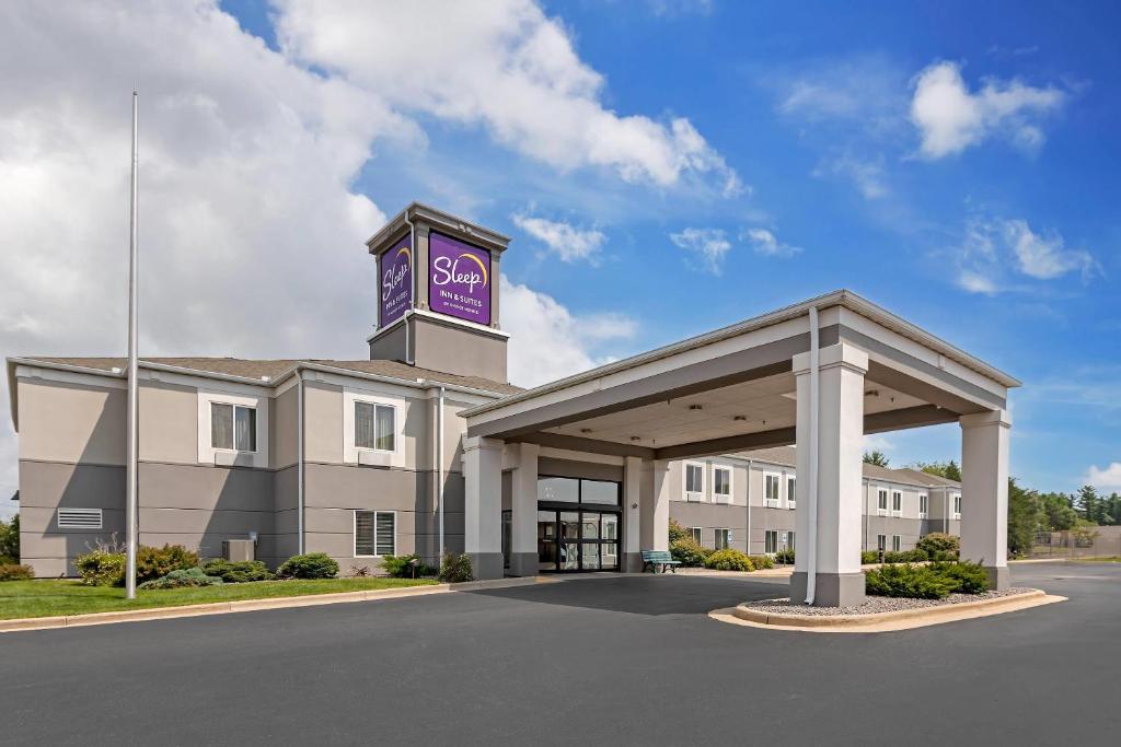 a hotel with a clock tower on top of a building at Sleep Inn & Suites in Wisconsin Rapids