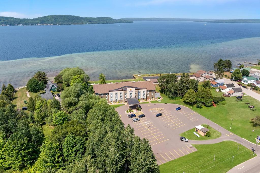 an aerial view of a building with a parking lot at Comfort Inn & Suites Munising-Lakefront in Munising