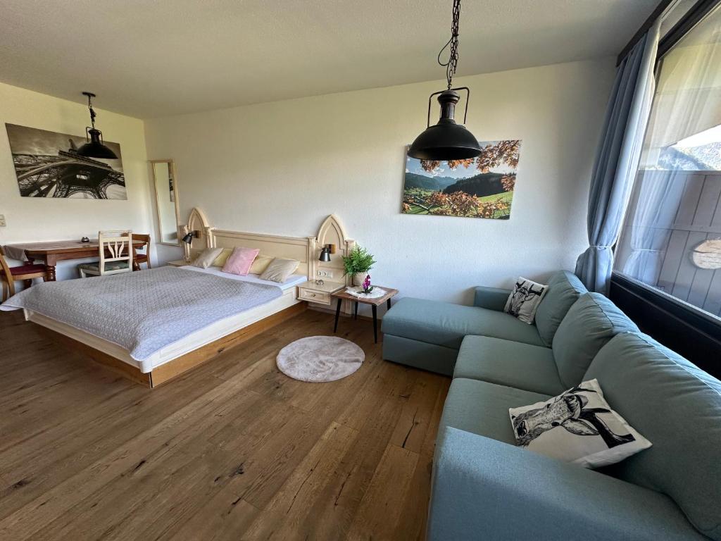 a living room with a couch and a bed at Steinbock Apartement in Bad Goisern