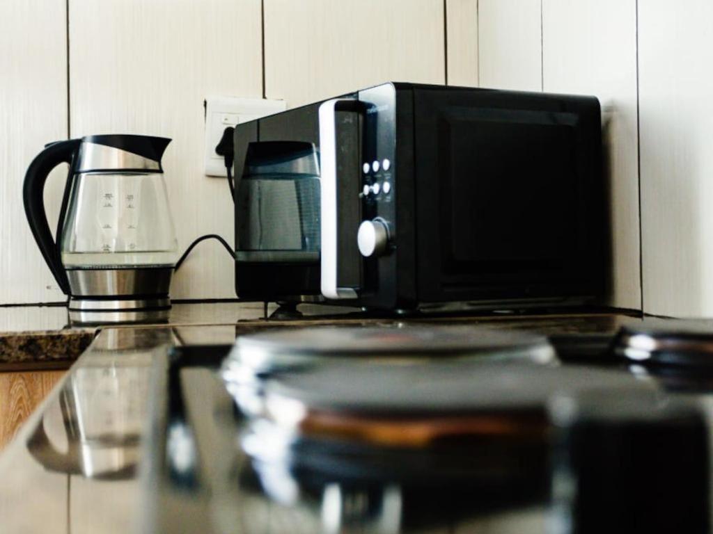 a microwave sitting on top of a kitchen counter at At 32 Michael in Klerksdorp