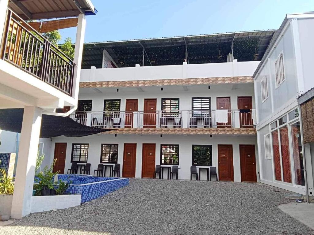 a courtyard of a building with tables and chairs at Casa Benito Resort 