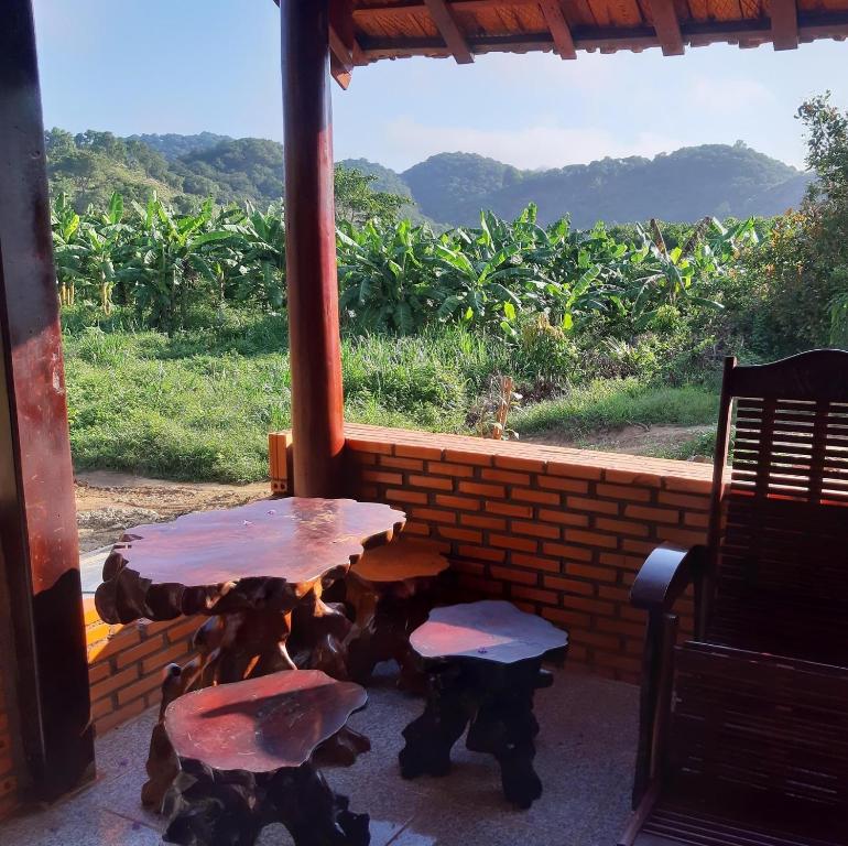 a table and two chairs in front of a window at Du Nam Riverside in Tân Phú