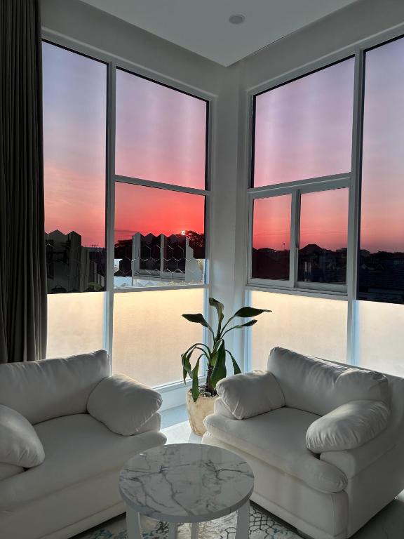 a living room with two white couches and a table at Klissy Studio Villa in Kerobokan