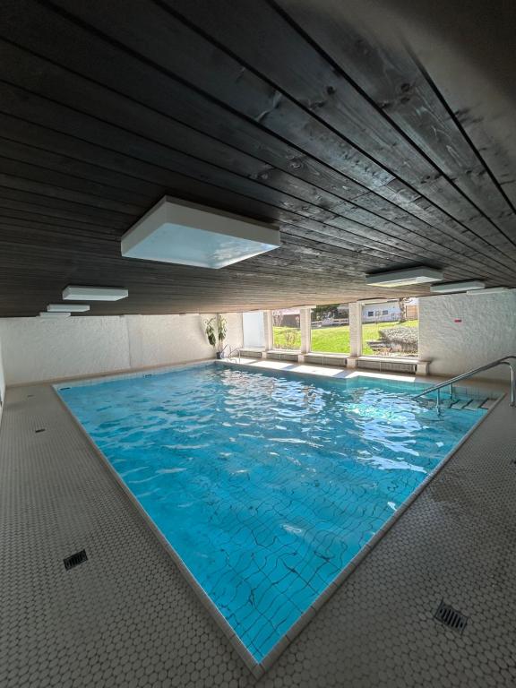 an overhead view of a large swimming pool at Allgäu Loft Obermaiselstein mit Privatsauna in Obermaiselstein