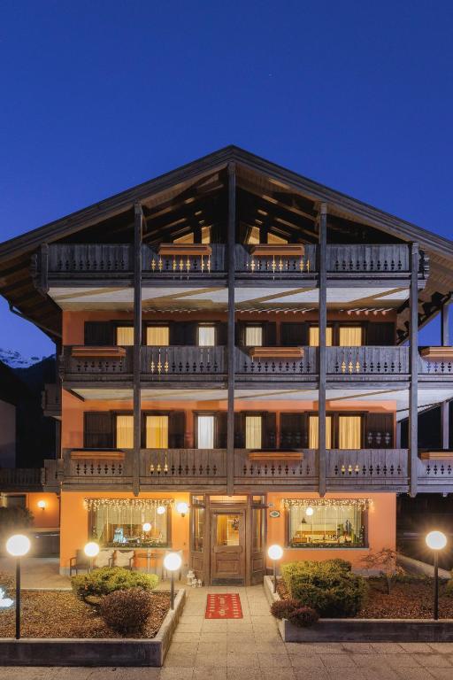 a large building with a balcony on top of it at Hotel Binelli in Pinzolo