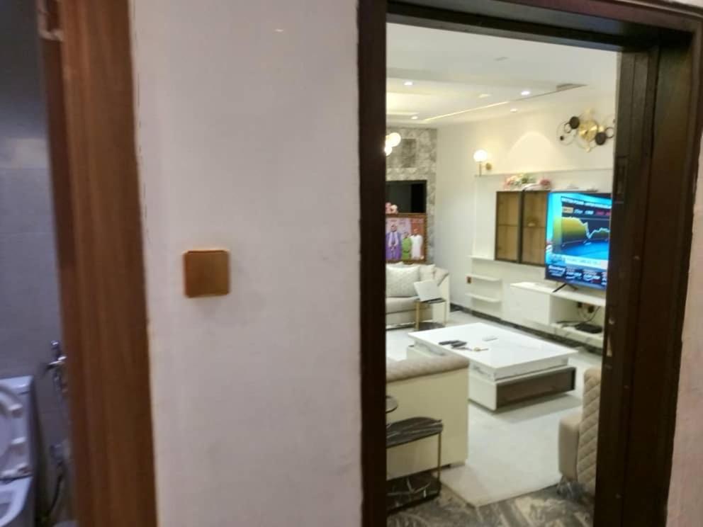 a room with a kitchen with a blue car in it at Tastefully furnished 4bedrooms Guzape with pool in Abuja