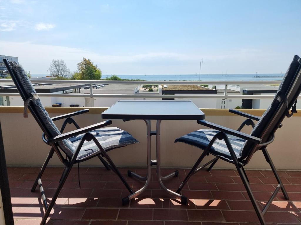 two chairs and a table on a roof at Wohnung Südstrand Glück in Fehmarn