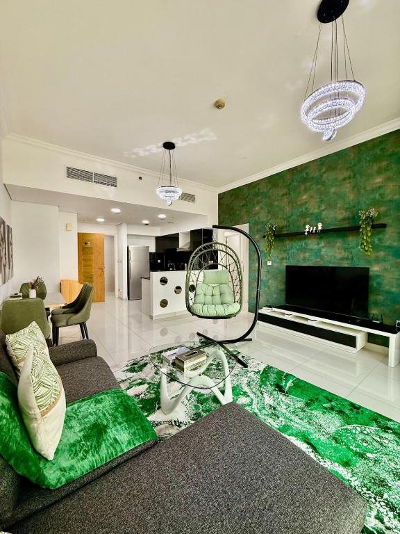a living room with a couch and a tv at Spacious Luxury Lagoon View 2Bhk in Dubai