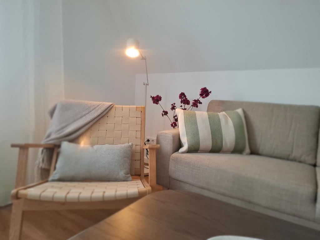 a living room with a couch and a chair at Bright 3-room apartment - space for family & friends in Tecklenburg