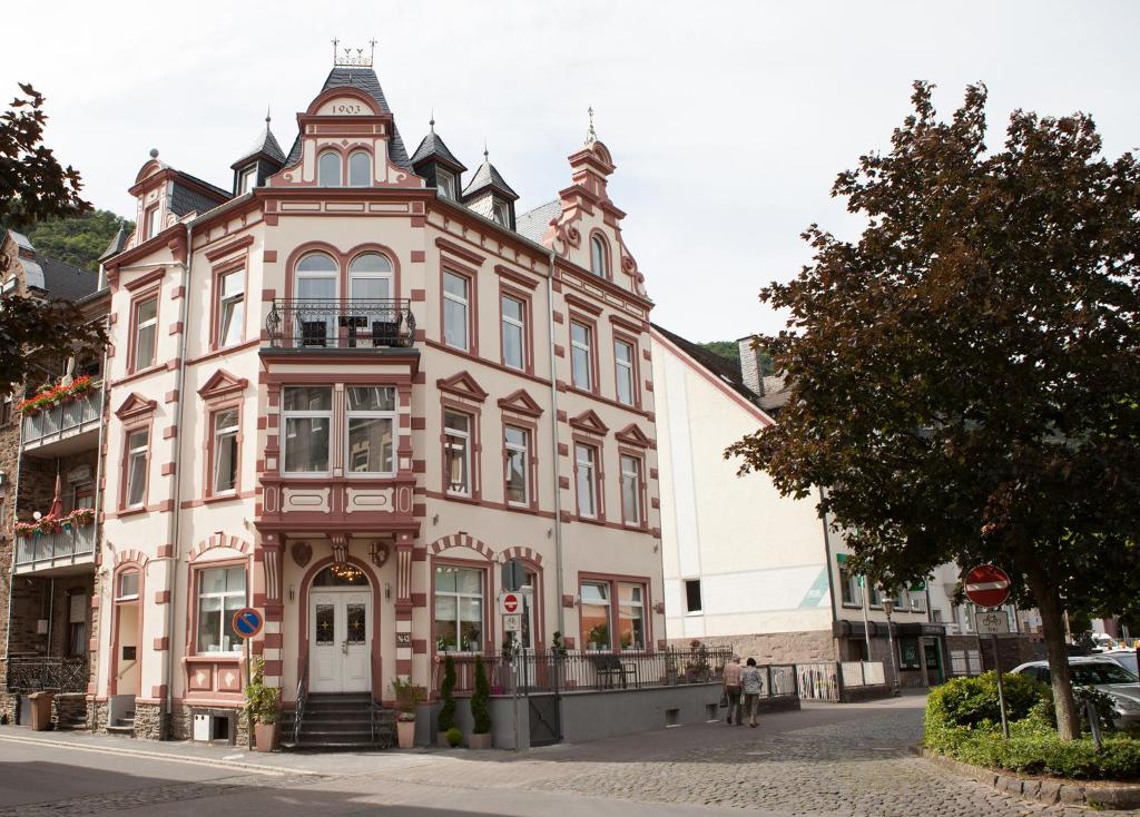 a large pink building on a city street at Hotel Ravene in Cochem