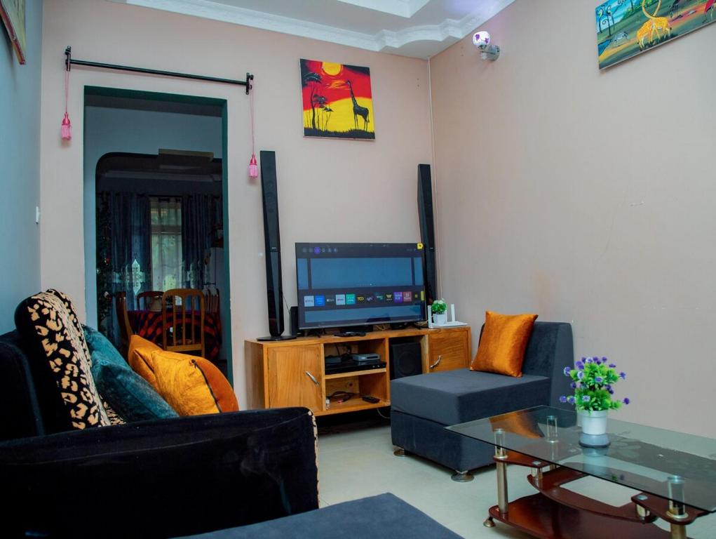 a living room with a couch and a television at Michelle Mountain Villa Retreat in Kirua