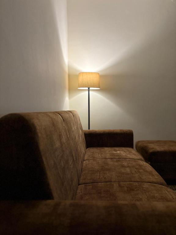 a living room with a couch and a lamp at 1 BHK Upper Tapovan Eternal Stayz in Rishīkesh
