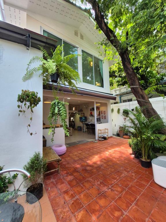a house with a patio with plants on it at Cat House BKK in Bangkok