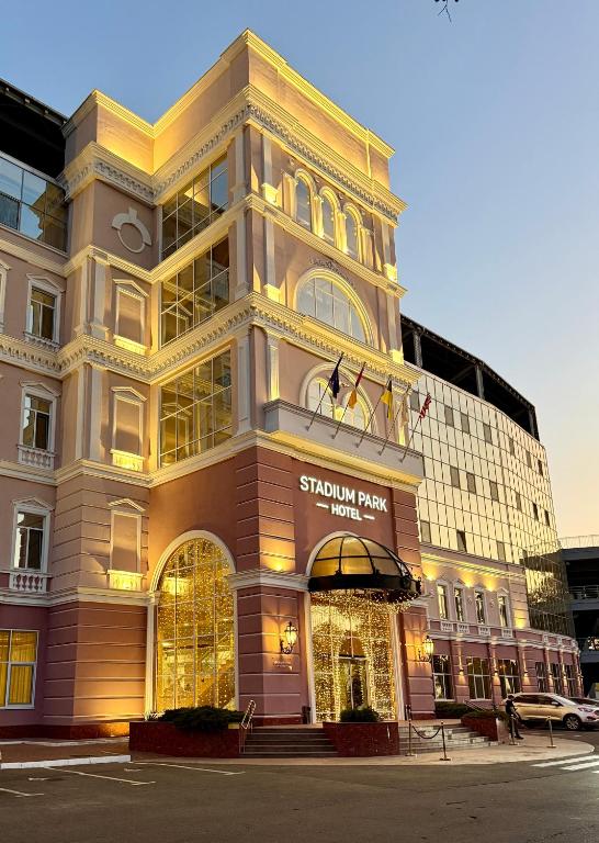 a building with a sign on the front of it at Stadium Park Hotel in Odesa