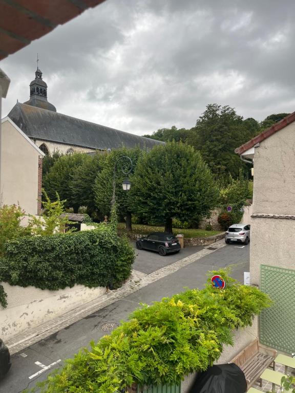 a view of a house with cars parked on a street at Le Clos Haton - HAUTVILLERS in Hautvillers
