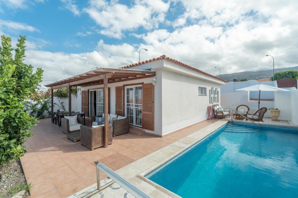 a villa with a swimming pool and a house at Villa Callao Salvaje Sunset in Callao Salvaje