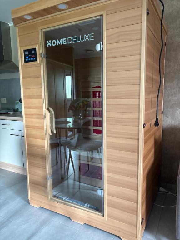a glass door in a kitchen with a table at Studio Les Champs in Baelen