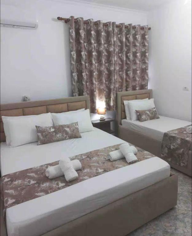 a bedroom with two beds and a window at Kruti house in Përmet