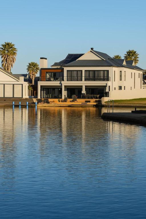 a large white building next to a body of water at 1442 Marina by Double Portion in Jeffreys Bay