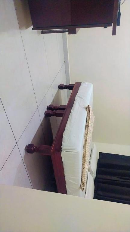 a white couch in a corner of a room at HOTEL OM VADODARa in Vadodara