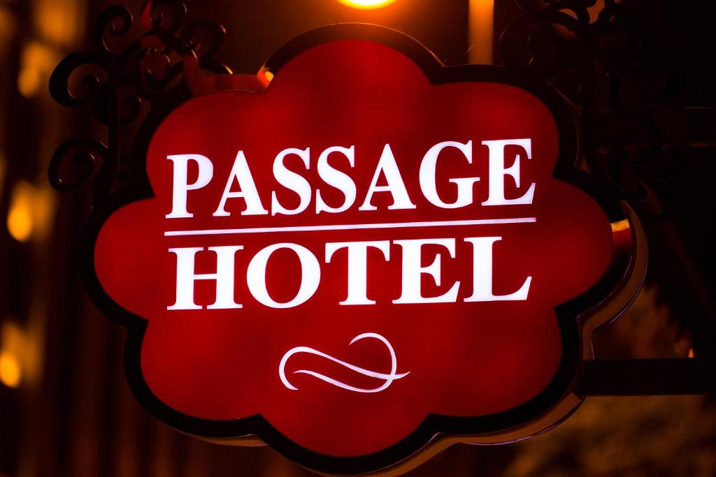 a neon sign for a massage hotel at Passage Hotel in Baku