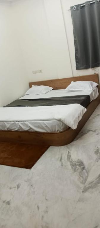 two beds sitting next to each other in a bedroom at Nest-In Homes in Hyderabad