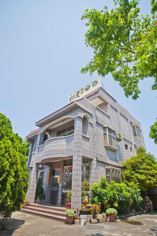 a building with a sign on top of it at Song Youf Hostel in Zhongpu