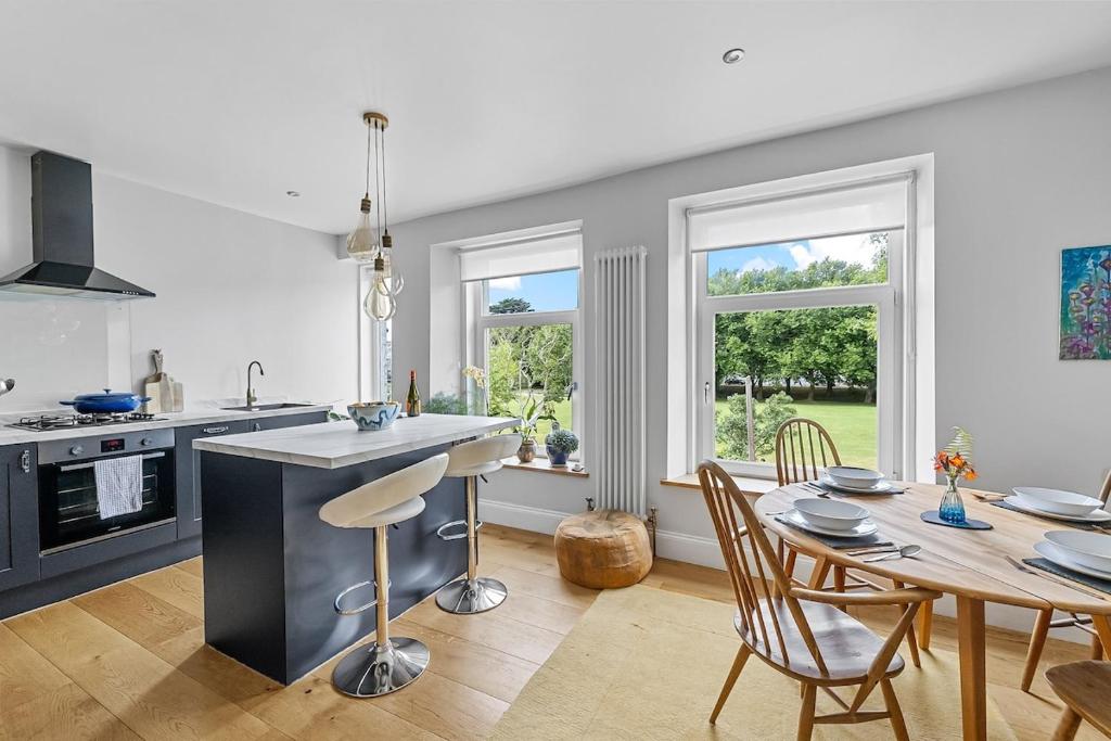 a kitchen and dining room with a table and chairs at Arundel House - Parkview with free parking in Plymouth