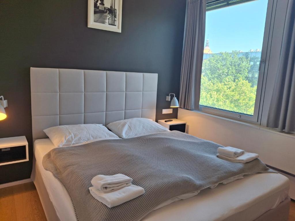 a bedroom with a large bed with towels on it at Apartmens Libertas in Vienna