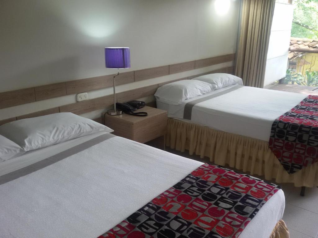 Postel nebo postele na pokoji v ubytování Hotel el Tesoro