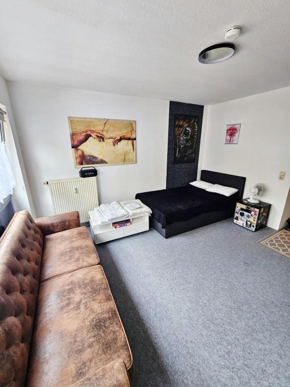 a living room with a couch and a bed at City Apartment in Kaiserslautern