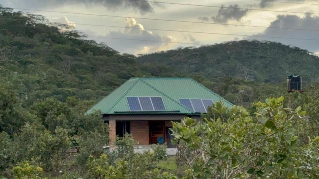 a house with a green roof with solar panels on it at Shiwa riverside apartment 
