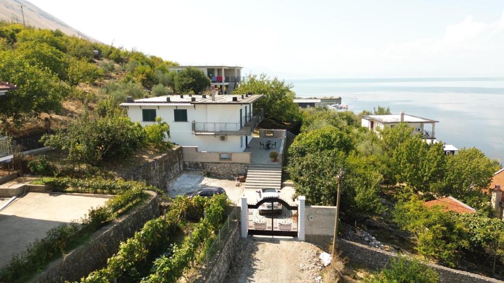 a house on a hill overlooking the ocean at Emerald House Shiroke in Shkodër