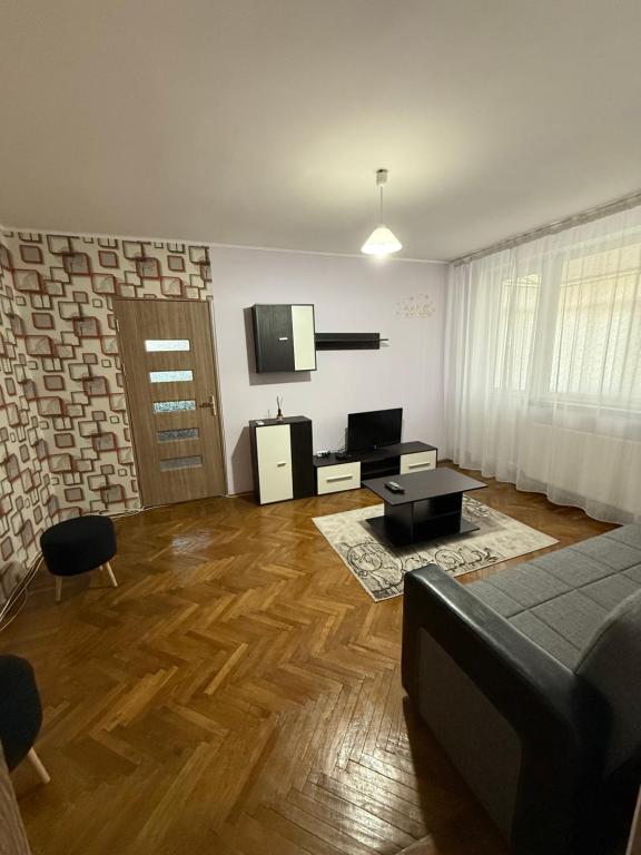 a living room with a couch and a tv at Apartament BLD N Titulescu in Craiova