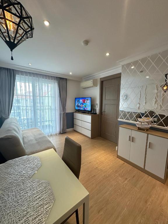 a living room with a couch and a table and a tv at Seven Seas Cote d'Azur D807 - 1 bedroom Cozy apartments in a premium Condo near the sea Бронирование открыто in Na Jomtien