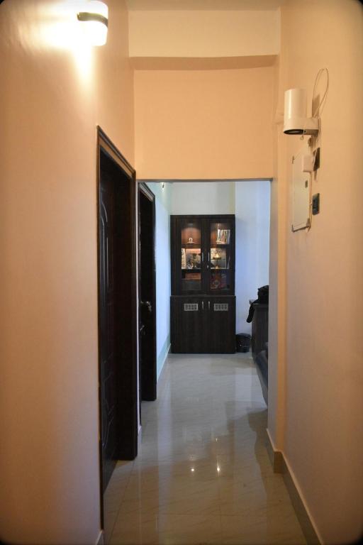 a hallway leading to a room with a door and a hallway at Regal homes in Tezpur